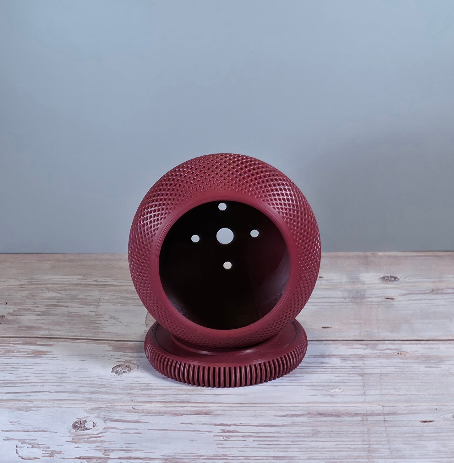 Maroon Mesh Planter with Round Drip Tray against Light Grey Background