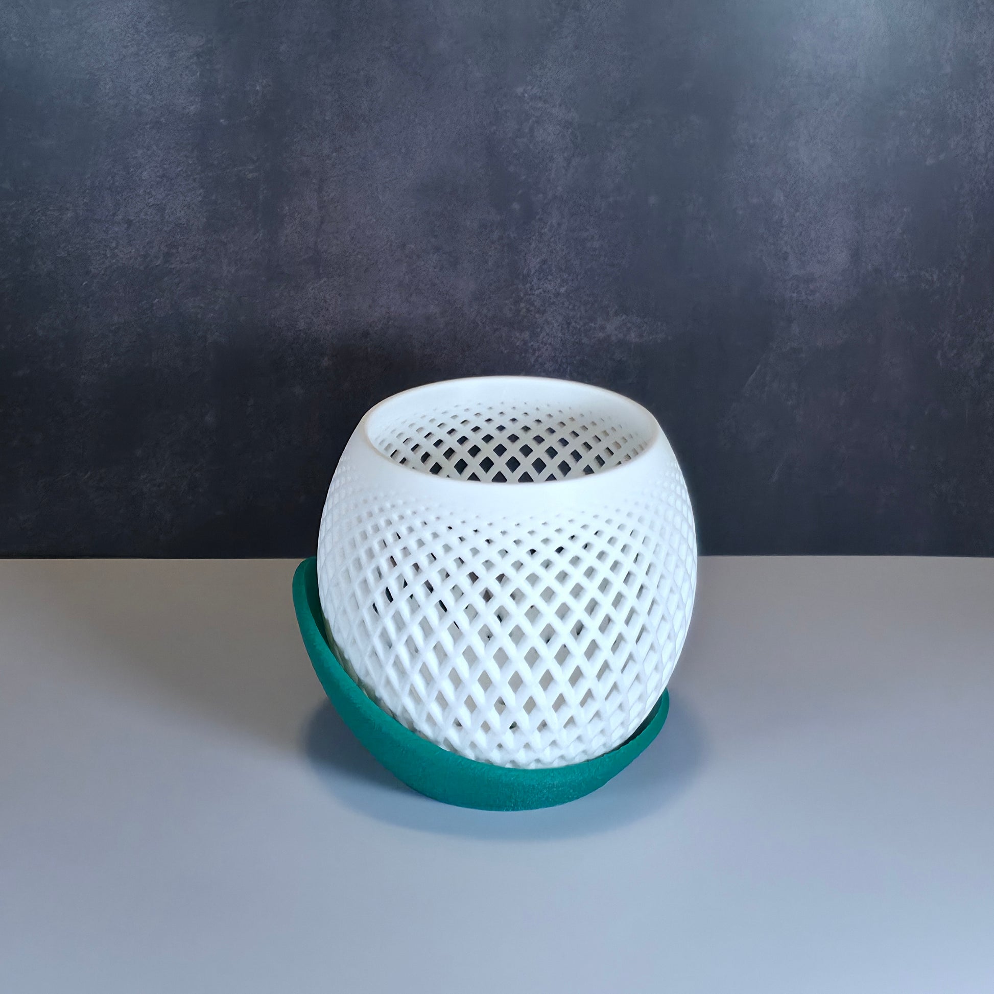 White Mesh Planter and Green Drip Tray against Dark Background