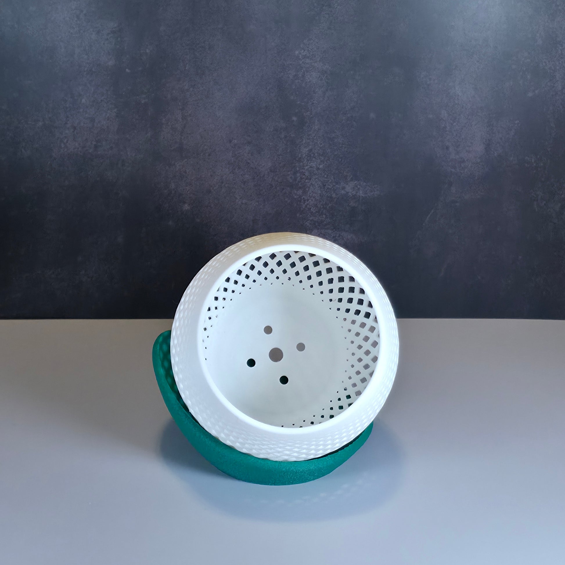 White Mesh Planter and Green Drip Tray against Dark Background