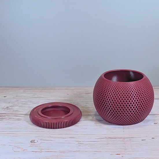 Maroon Mesh Planter with Round Drip Tray against Light Grey Background